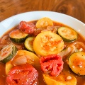 summerItaliansquashwithtomatoesinawhitebowl